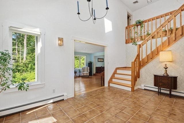 187 Middle Rd, Southborough, MA 01772 - tiled foyer entrance with a baseboard radiator, stairs, a chandelier, and a towering ceiling