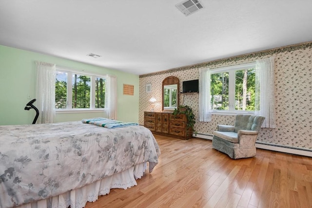187 Middle Rd, Southborough, MA 01772 - bedroom featuring wallpapered walls, a baseboard heating unit, and light wood-type flooring