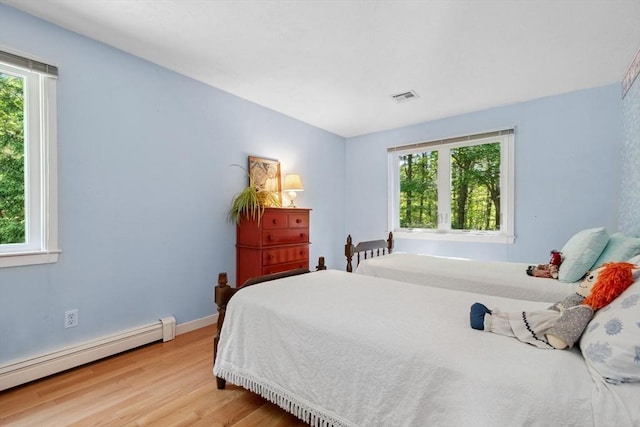 187 Middle Rd, Southborough, MA 01772 - bedroom featuring a baseboard radiator, multiple windows, wood finished floors, and baseboards