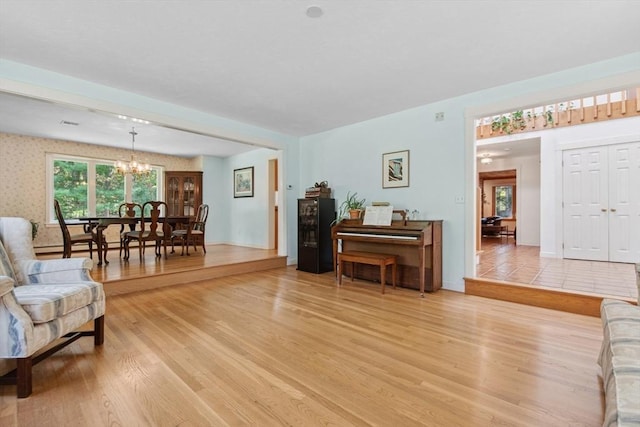 187 Middle Rd, Southborough, MA 01772 - living room featuring a chandelier, light wood-type flooring, and baseboards