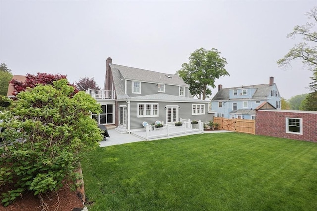 rear view of house with a patio area and a chimney