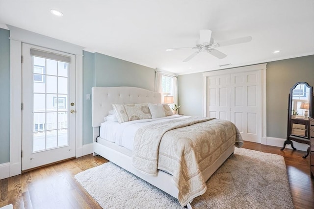 bedroom featuring wood finished floors, baseboards, ceiling fan, recessed lighting, and a closet