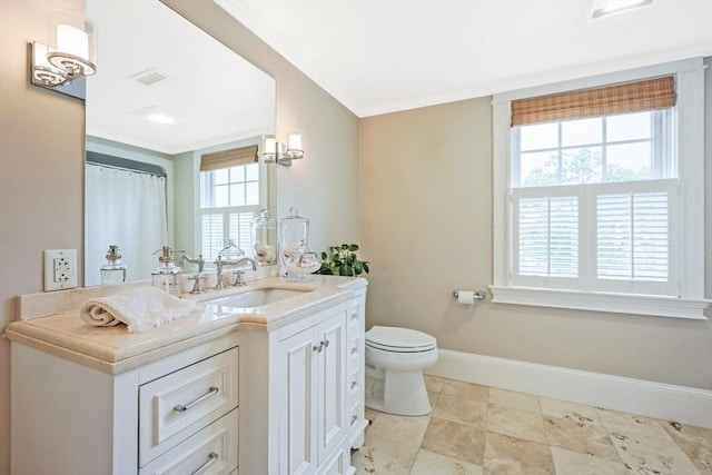 bathroom with toilet, vanity, baseboards, ornamental molding, and a shower with shower curtain