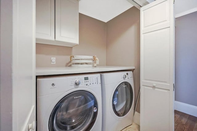 laundry area with separate washer and dryer, baseboards, wood finished floors, and cabinet space