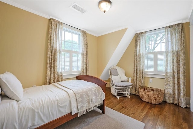 bedroom featuring crown molding and wood finished floors