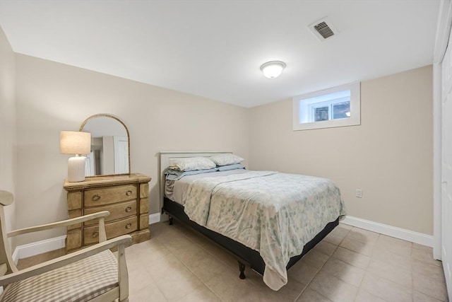 bedroom with baseboards and light tile patterned floors