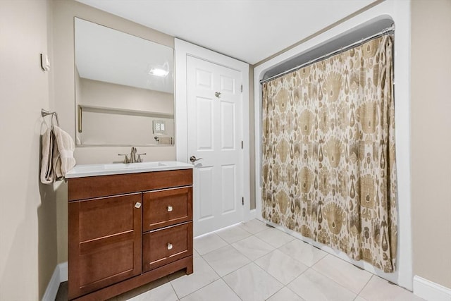 full bathroom featuring vanity, baseboards, a shower with curtain, and tile patterned flooring