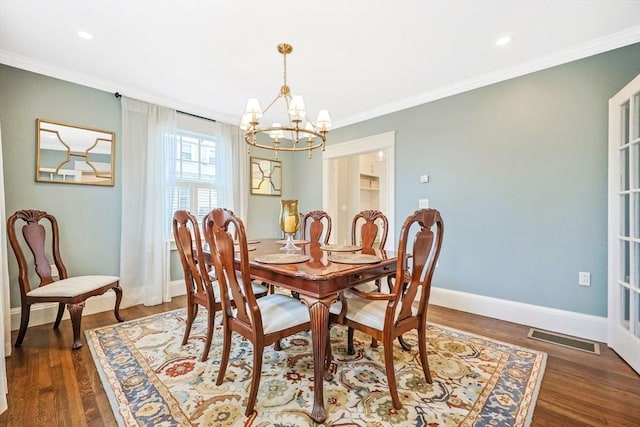 dining room with a chandelier, ornamental molding, baseboards, wood finished floors, and recessed lighting