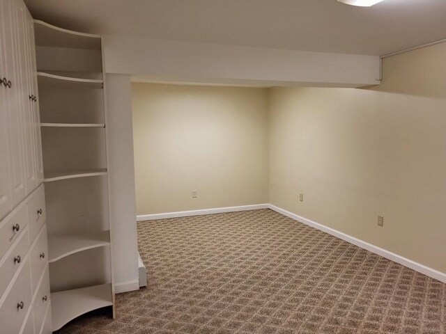 finished basement featuring baseboards and carpet