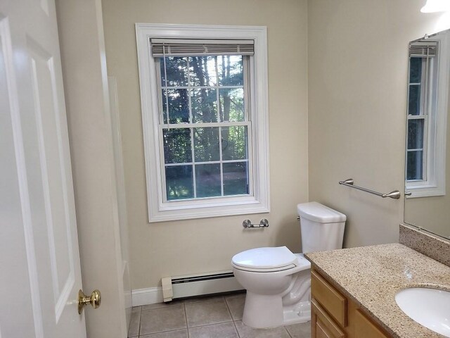 bathroom featuring toilet, vanity, a baseboard radiator, tile patterned flooring, and baseboards