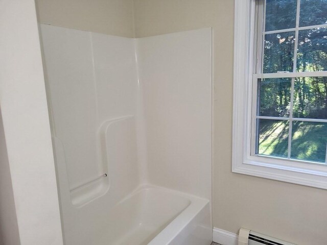 full bath featuring a bathtub, a shower, and a baseboard radiator
