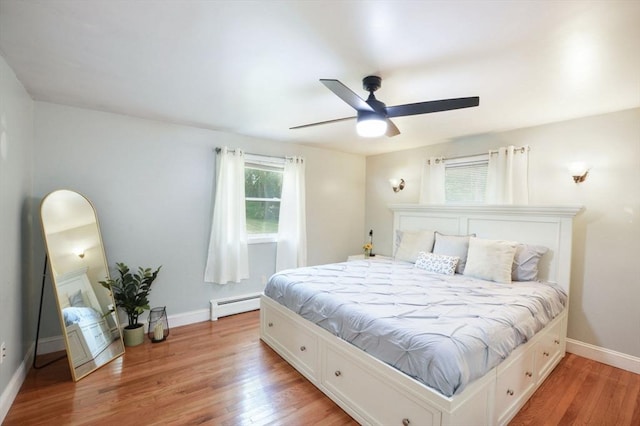 64 Charlotte White Rd Unit 2, Westport, MA 02790 - bedroom featuring a baseboard heating unit, light wood-style floors, and a ceiling fan