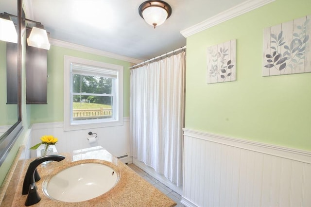 64 Charlotte White Rd Unit 2, Westport, MA 02790 - full bathroom with wainscoting, vanity, crown molding, a baseboard radiator, and tile patterned flooring