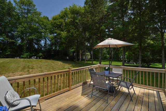 64 Charlotte White Rd Unit 2, Westport, MA 02790 - wooden deck with outdoor dining space, a lawn, and view of scattered trees
