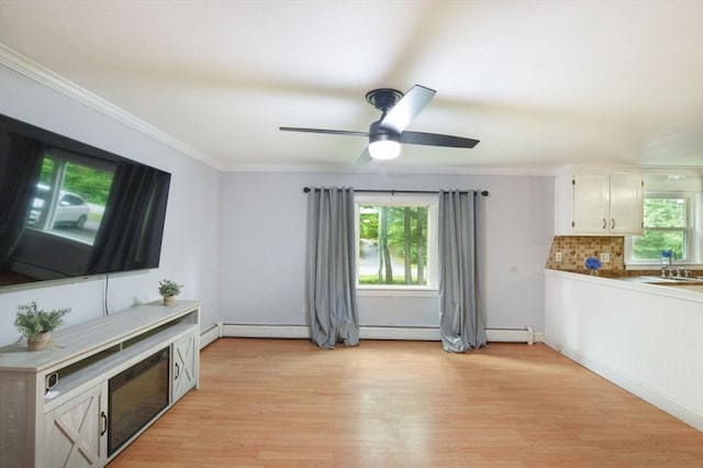 64 Charlotte White Rd Unit 2, Westport, MA 02790 - living room with light wood-type flooring, ornamental molding, a ceiling fan, and a baseboard radiator