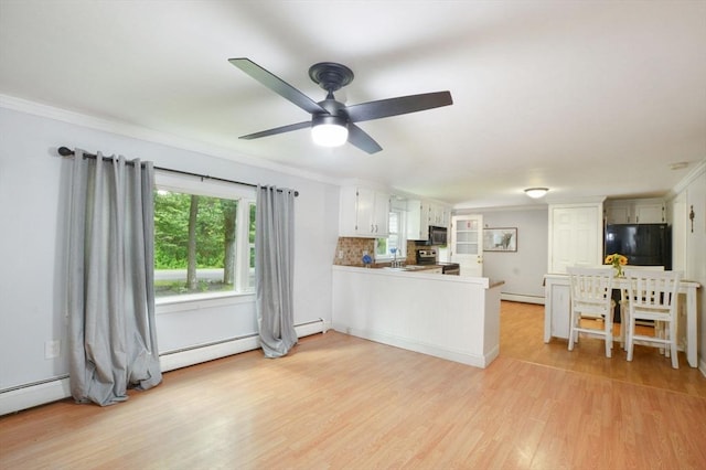 64 Charlotte White Rd Unit 2, Westport, MA 02790 - kitchen with refrigerator, crown molding, light wood-style flooring, a peninsula, and ceiling fan