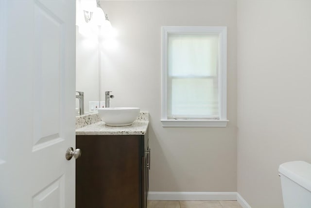 bathroom featuring tile patterned flooring, vanity, and toilet