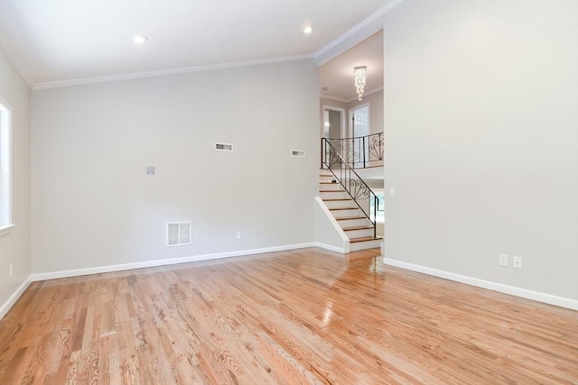 empty room featuring ornamental molding and light hardwood / wood-style floors