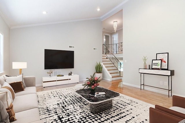 living room with hardwood / wood-style flooring and ornamental molding