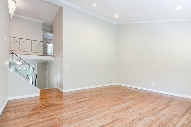 unfurnished living room featuring ornamental molding and light hardwood / wood-style floors