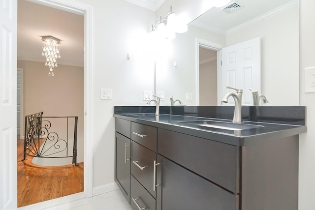 bathroom featuring crown molding and vanity