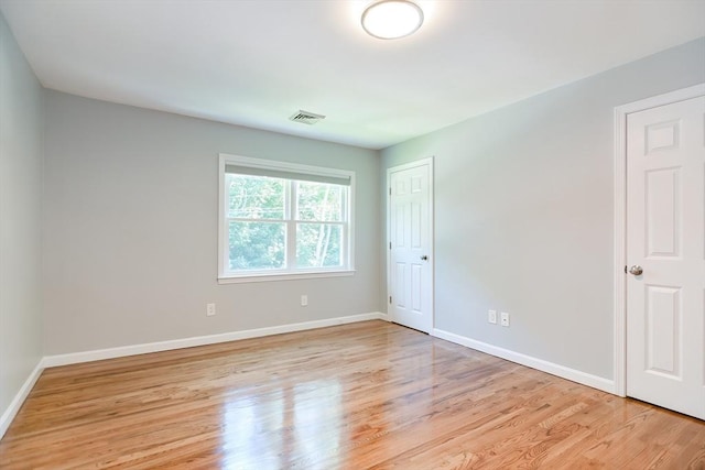 empty room with light hardwood / wood-style floors