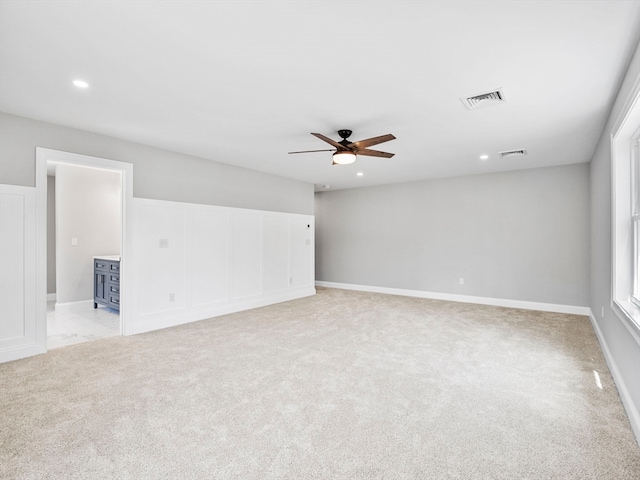 empty room featuring light carpet and ceiling fan