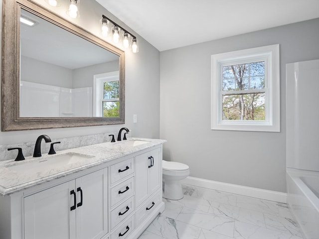 bathroom featuring vanity, toilet, and a wealth of natural light