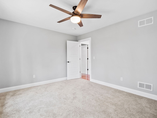 carpeted spare room featuring ceiling fan