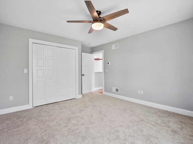 unfurnished bedroom with a closet, ceiling fan, and carpet flooring