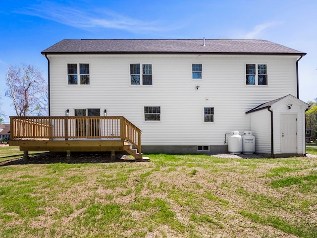 back of house with a deck and a yard