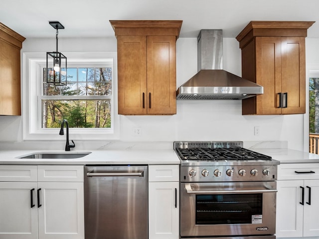 kitchen with wall chimney exhaust hood, white cabinetry, sink, and stainless steel appliances