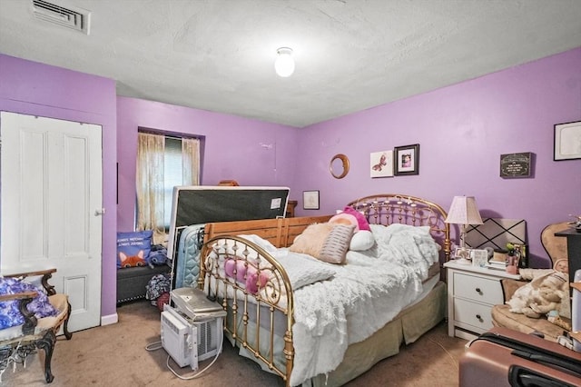 bedroom featuring a closet, visible vents, and carpet floors