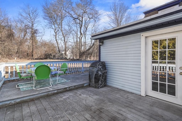 wooden terrace with grilling area and a pool