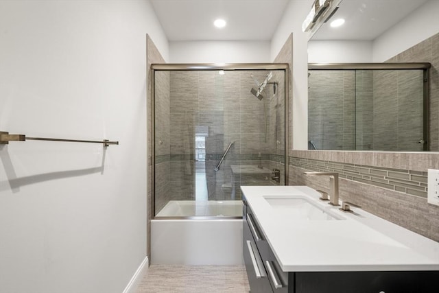 bathroom featuring vanity, enclosed tub / shower combo, and recessed lighting