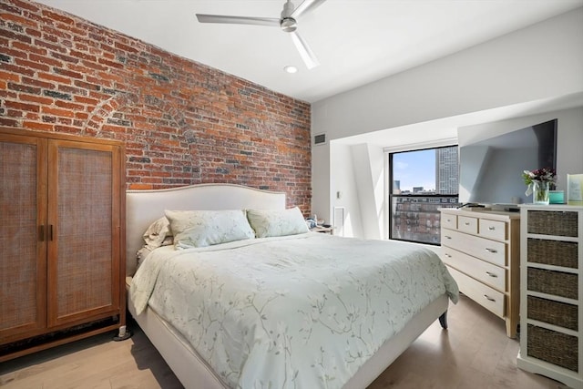 bedroom featuring brick wall, light wood finished floors, ceiling fan, and recessed lighting