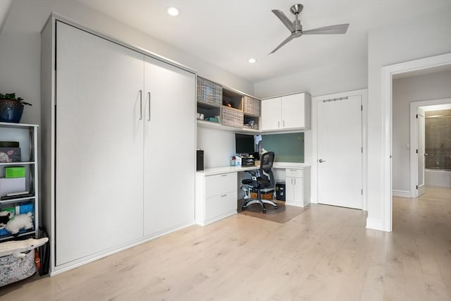 office space featuring built in desk, a ceiling fan, light wood finished floors, and recessed lighting