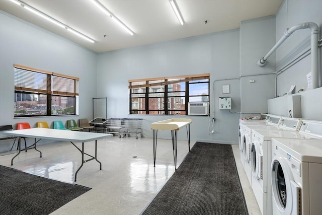 community laundry room with washer and dryer, plenty of natural light, cooling unit, and light floors