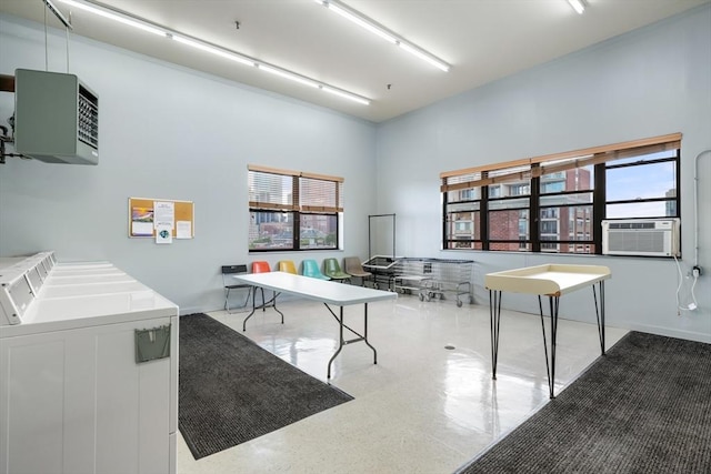 home office with washer / dryer, cooling unit, a towering ceiling, and a heating unit