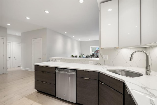 kitchen with a sink, stainless steel dishwasher, modern cabinets, dark brown cabinets, and recessed lighting