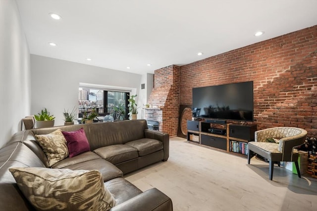 living room with brick wall, light wood finished floors, and recessed lighting