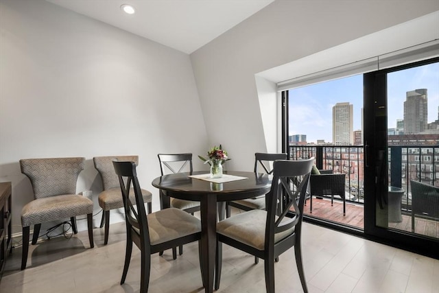 dining space with a view of skyline and recessed lighting