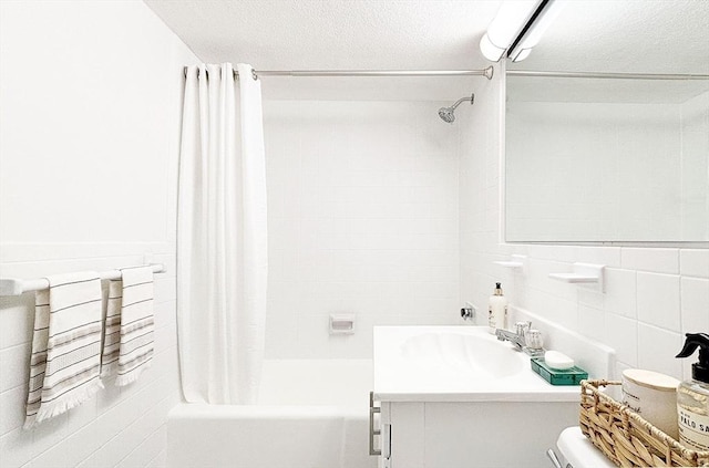 585 Revere Beach Pkwy Unit 410, Revere, MA 02151 - full bathroom featuring tile walls, shower / tub combo, vanity, and a textured ceiling