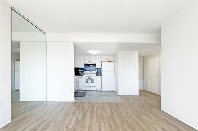 585 Revere Beach Pkwy Unit 410, Revere, MA 02151 - kitchen featuring white appliances, light wood-style flooring, white cabinetry, and under cabinet range hood