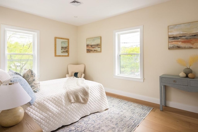 24 Ivory St, Boston, MA 02132 - bedroom featuring wood finished floors, multiple windows, and baseboards