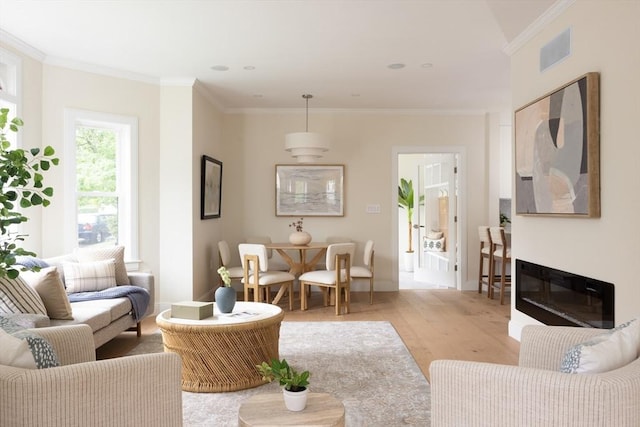 24 Ivory St, Boston, MA 02132 - living area with light wood-style flooring, crown molding, baseboards, and a glass covered fireplace