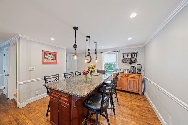 57 Century Rd, Weymouth, MA 02190 - kitchen with a kitchen breakfast bar, crown molding, light wood-style floors, recessed lighting, and a center island