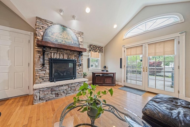 57 Century Rd, Weymouth, MA 02190 - living area featuring vaulted ceiling, a stone fireplace, french doors, wood finished floors, and recessed lighting
