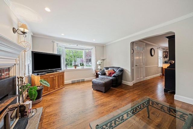 57 Century Rd, Weymouth, MA 02190 - living room with arched walkways, wood finished floors, baseboards, crown molding, and recessed lighting