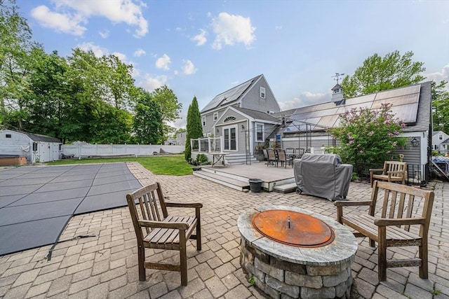 57 Century Rd, Weymouth, MA 02190 - view of patio / terrace featuring an outdoor fire pit, area for grilling, a wooden deck, an outdoor structure, and a fenced backyard